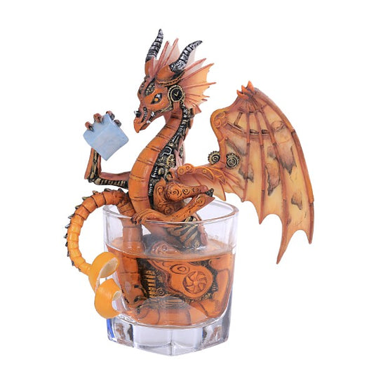 An intricately designed orange STEAMPUNK DRAGON, crafted by Stanley Morrison using cold cast resin, features gears and mechanical elements as it sits inside a glass of amber liquid. The dragon holds a blue cube in one claw and a curled lemon peel decorates the side of the glass. Available at Raven Moon Gift Store.